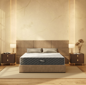 A Puffy Cloud Memory Foam Mattress on a bed frame in a bright bedroom, showcasing the mattress's design and color.